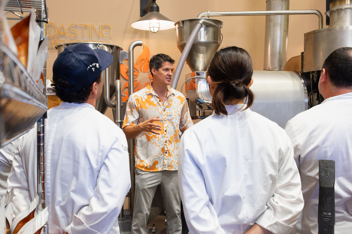 Tradition founder Brian Burik teaching culinary students in chef whites at the roastery, Kona coffee