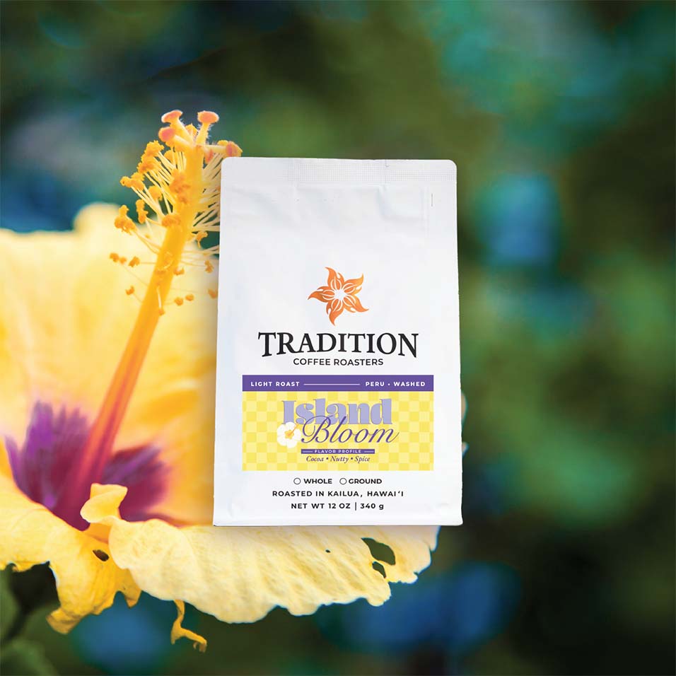 Tradition Coffee Roasters Island Bloom coffee package with a yellow flower in the background