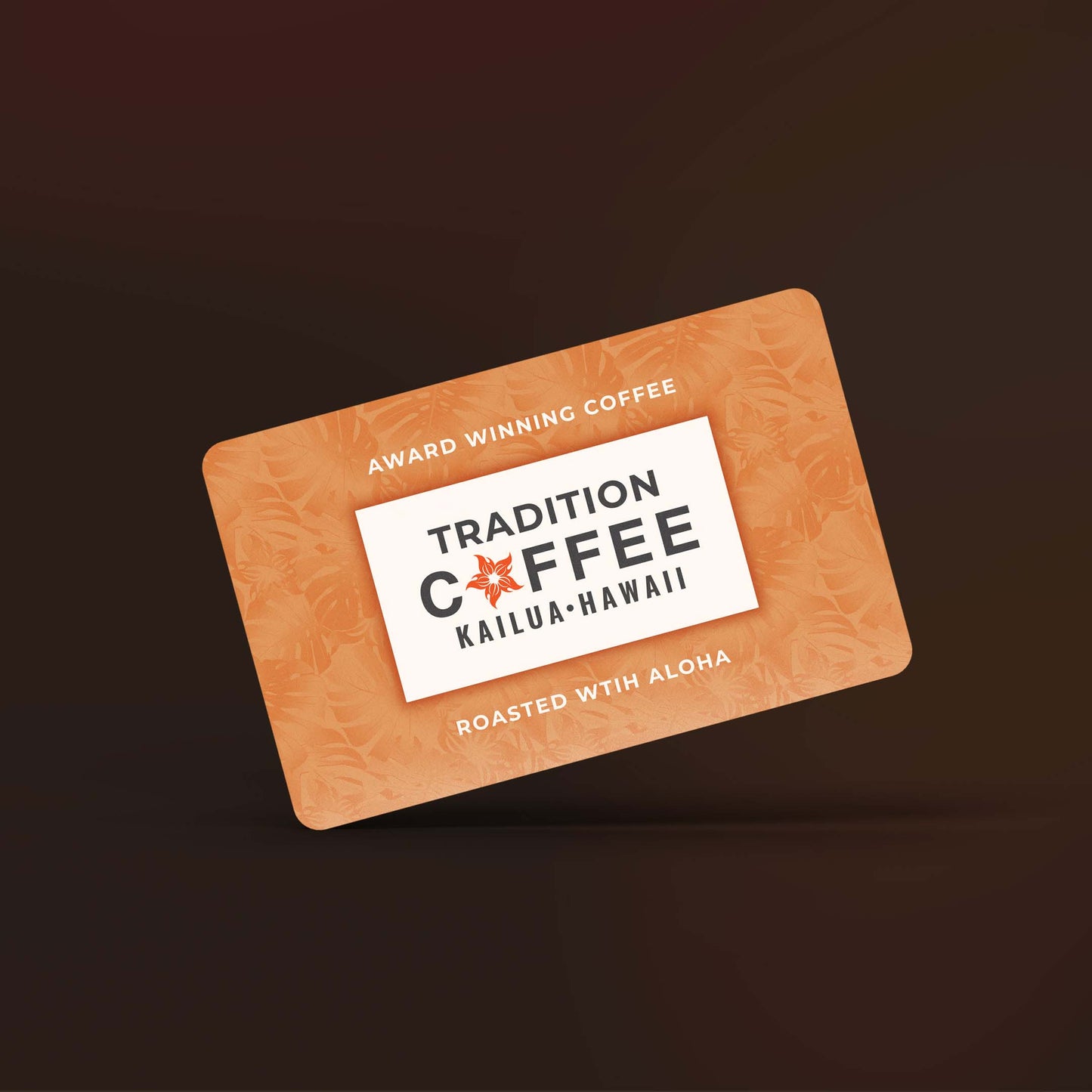 Tradition Coffee Roasters digital gift card displaying the brand logo against an orange tropical leaf pattern, with brown background