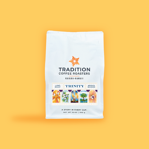 A white bag of Tradition Coffee Roasters Kailui-Hawaii coffee on a solid yellow background. The bag features the orange Tradition Coffee Roasters logo and a colorful graphic representing the Trinity Light roast Medium Washed coffee.