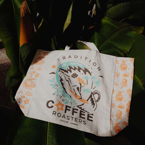 Tote bag with coffee roaster branding and design on a leafy background